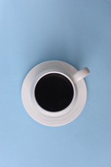 Top view of Coffee in cup on a blue background