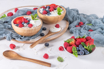 Yogurt and berries for healthy breakfast. Bowl of greek yogurt with raspberry, blueberries and strawberries