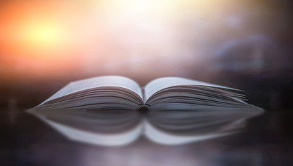 Abstract gold magic book on wooden background