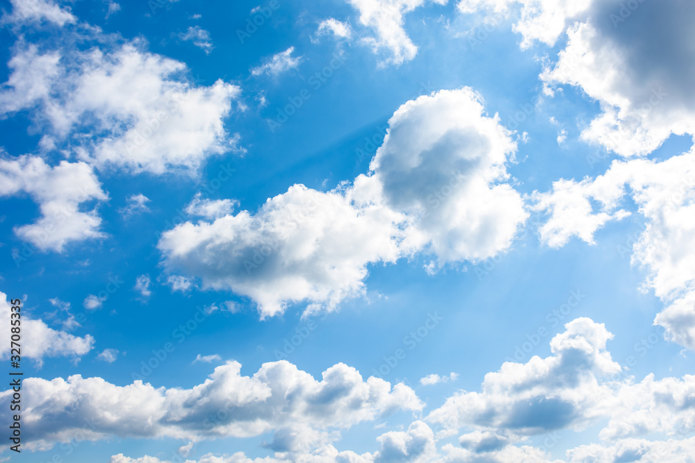 Wall mural gorgeous cloudscape in springtime. weather background with dynamic cloud arrangement on a blue sky. 