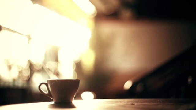 Close up shot of a hot coffee cup with steam coming out of it, in a morning, in Bucharest, Romania.