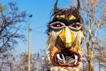 Horned male kuker mask at the National Festival Dervishi Varvara 2019, village of Varvara, Pazardzhik Province, Rhodope Mountains, Bulgaria