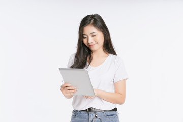 Young beautiful Asian woman in business office standing use tablet in hand, Thai girl enjoy browsing for online shopping store with copy space for advertisement, on isolated white background