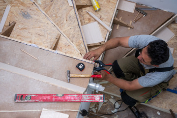 carpenter installing wooden stairs