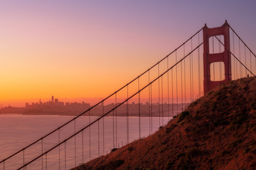 Golden Gate bridge at sunrise with a person