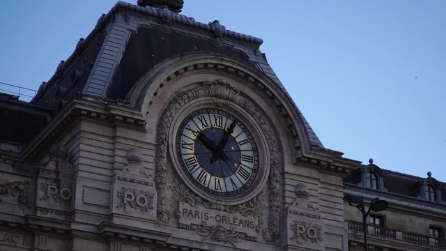 Historic clock on building facade. Mus&eacute;e d'Orsay. Glide shot. Paris tourism attraction & famous landmark. Romantic honeymoon travel destination.