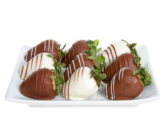 Rectangular porcelain plate of giant strawberries dipped in white and milk chocolate, drizzled with contrasting white and milk chocolate. Isolated on white