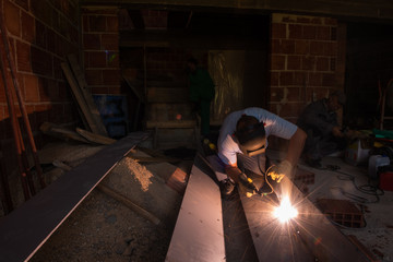 welder with protective mask welding steel