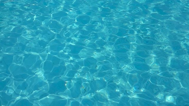 Calm blue wave water of pool. Close up. Slow motion.