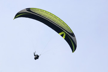 Paraglider flying wing in a blue sky	