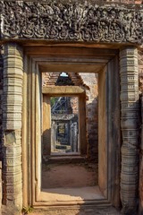 old pillars leading through passage of ancient angkor wat ruins, cambodia