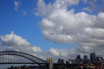 water plane flying over Sydney Harbour bridge 