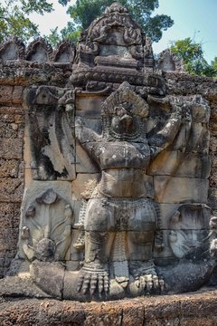 old ancient stone carving statue of hindu, buddha god symbol in angkor wat temple, cambodia