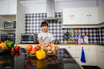 Happy Family  and their little daughter Cooking Together in the Kitchen