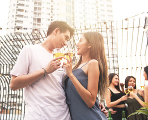 asian couple dance together in party with friends
