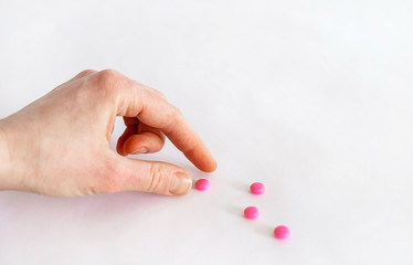 Tablets in hand on a white background close-up.