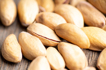 Pistachios in shell on the black rustic background. Selective focus. Shallow depth of field.