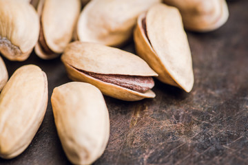 Pistachios in shell on the black rustic background. Selective focus. Shallow depth of field.