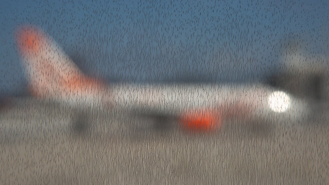 Abstract Of Dirty Window With Out Of Focus Airplane Silhouette In Airport Context With Shiny Reflection Of Front Windshield Against A Blue Sky