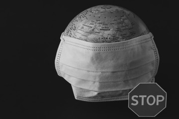 Coronavirus concept. Earth and mask to fight against Corona virus. Virus attack isolated on black background.