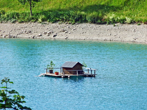 A small duck lodge on a artifical lake G&auml;nglesee (Ganglesee or Gaenglesee) and in the Saminatal alpine valley - Steg, Liechtenstein