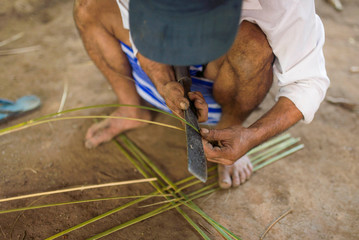 worker cutting wood with circular saw