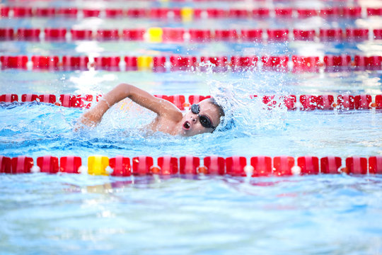Young boy swimming freestyle