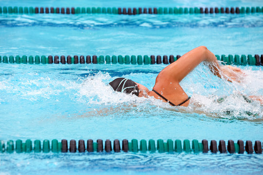 Freestyle swimmer racing in a pool