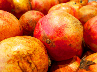 Ripe pomegranates on a shelf in a store