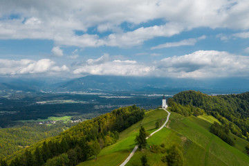 Aerial view of a white church on the mountain top, The Church Of St Primoz in Slovenia