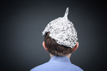 Boy in a tin foil hat from the back