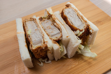 Three slices of katsu sando, pork cutlet sandwich.