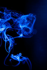 Blue smoke motion on black background.