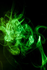 Green smoke motion on black background.