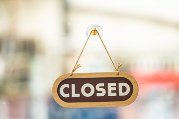 sorry we are closed sign hanging outside a restaurant, store, office or other