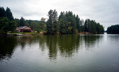 Fototapeta na wymiar Wonderful Lacamas Lake on a breezy cloudy morning with the wilderness reflecting in the calm shimmering water in Camas Washington