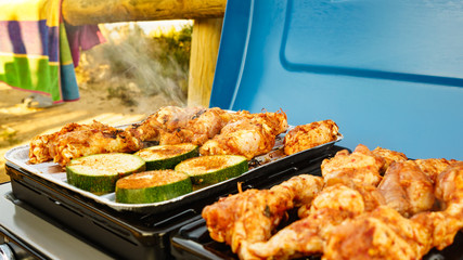 Chicken meat grilling on gas grill