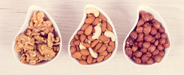 Various nuts and almonds in bowls, healthy nutrition and lifestyle concept