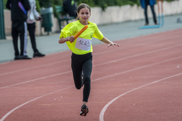 Obraz premium Isolated eleven year old girl in a track and field relay race- Israel