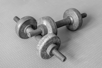 old metal rusty dumbbells in black and white photo