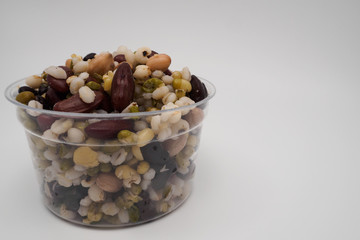 Mix of beans in a transparent cup, Zoom macro.