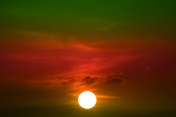 sunset on green red orange sky back soft evening cloud over space