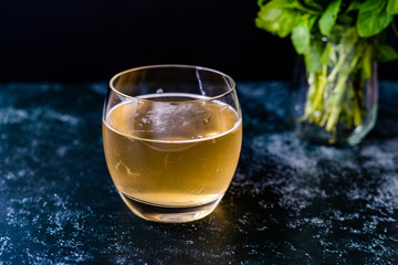 Homemade Traditional Healthy Fermented Raw Kombucha Tea with Mint Leaves in Glass Ready to Drink