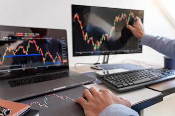 Businessman broker Analyzing finance data graphs and reports on screen for investment purposes for trading graph of stock market.