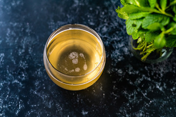 Homemade Traditional Healthy Fermented Raw Kombucha Tea with Mint Leaves in Glass Ready to Drink