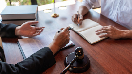 Fototapeta premium Male Notary lawyer or judge consult or discussing contract papers with Businessman client in office, Law and Legal services concept