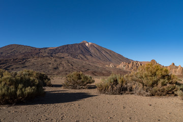  View of Roques de García unique rock formation with famous Pico del Teide mountain volcano summit in the background on a sunset, Teide National Park, Tenerife, Canary Islands, Spain
