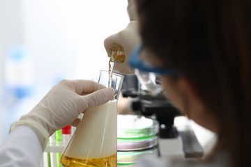 Laboratory assistant conducts analysis fluid. Chemical and technological control in production malt...