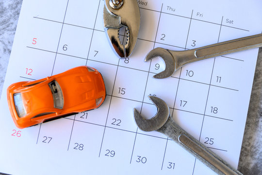 wrench and car on the calendar with numbers. repair concept