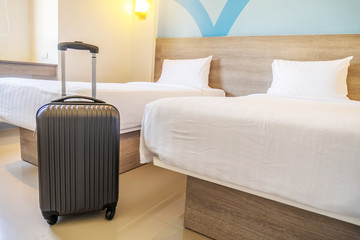 Black travel suitcase or luggage bag in a modern hotel room - relaxing time, holidays, weekend and...